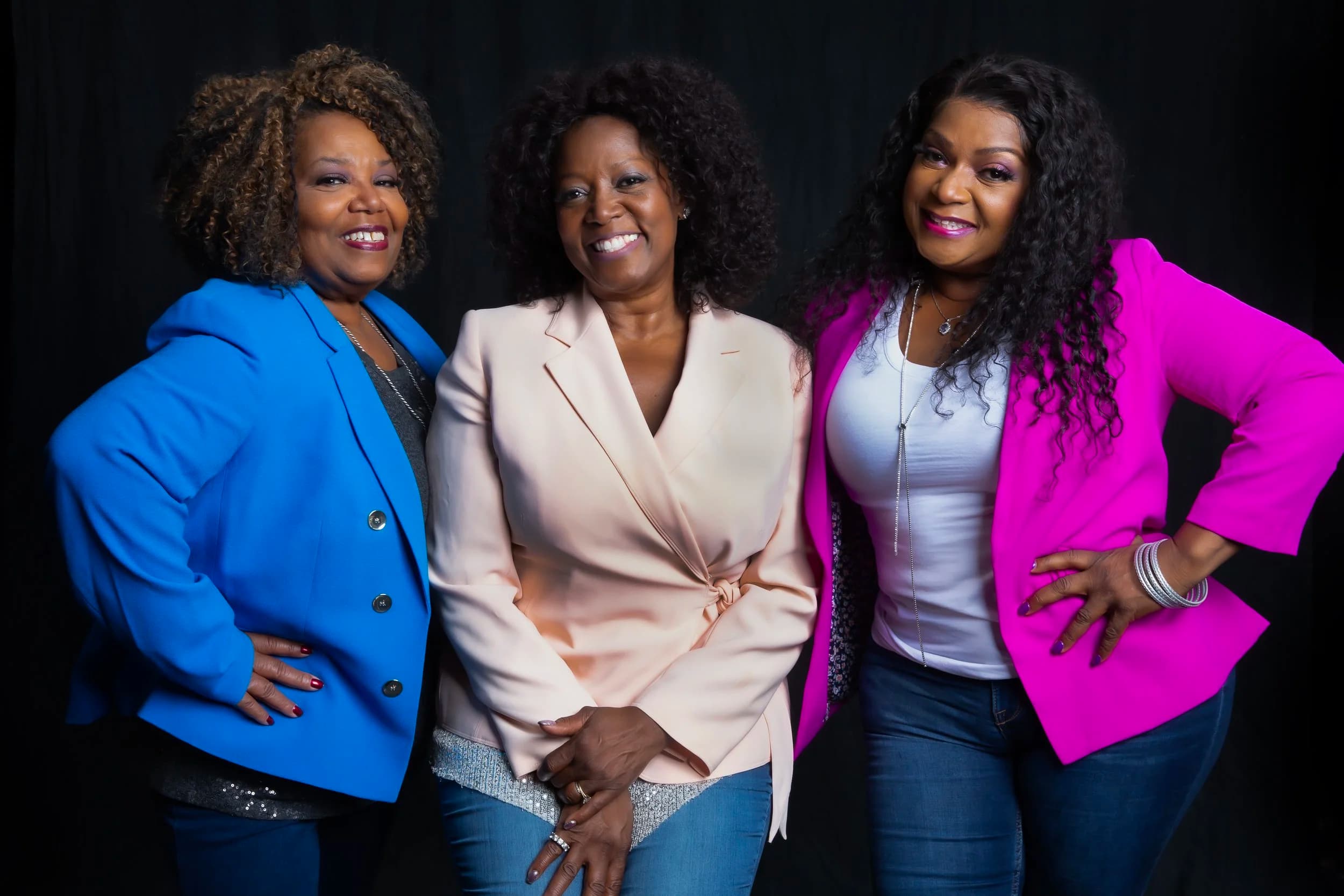 The McCrary Sisters together, smiling in a studio portrait